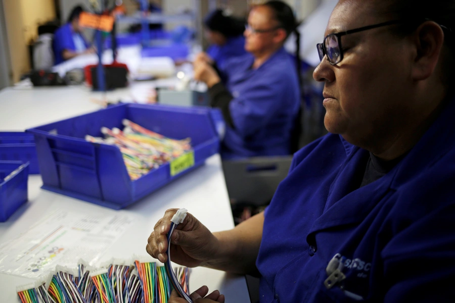 Operators work at a wire harness and cable manufacturing plant as the fast-spreading coronavirus outbreak has rippled through the global economy and upended supply chains, in Ciudad Juarez, Mexico March 11, 2020. 