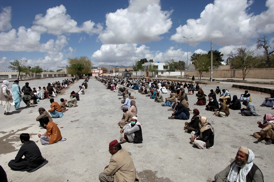 People in Quetta, Pakistan wait for ration handouts from a charity during a national lockdown