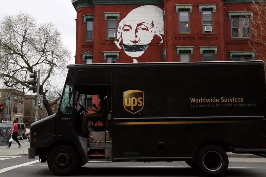 A local mural takes on new meaning while a United Parcel Service (UPS) delivery truck pauses at a traffic light, as the spread of coronavirus disease (COVID-19) continues in Washington, U.S., March 27, 2020.