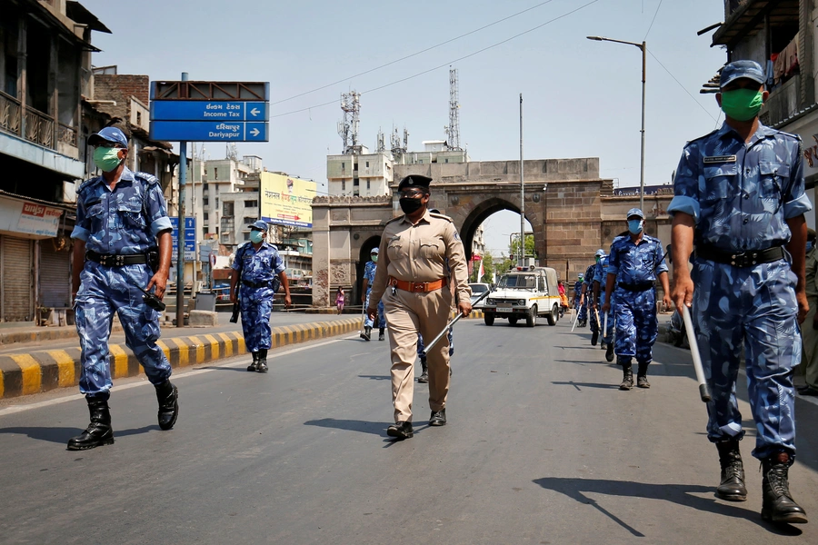 Members of India's specialized police force patrol a street in Ahmedabad during the lockdown.