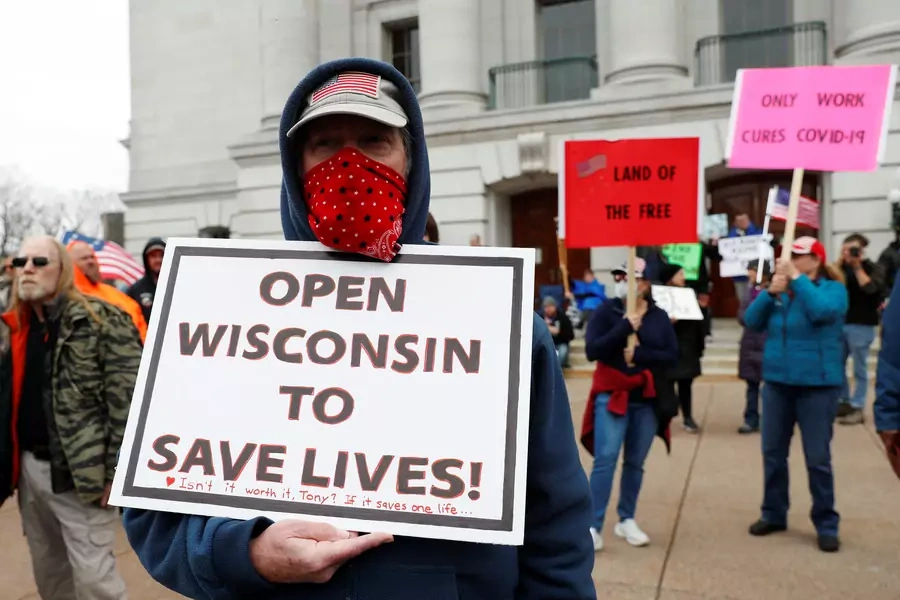 A demonstrator protests the extension of the emergency Safer at Home order by State Governor Tony Evers to slow the spread of the coronavirus disease.