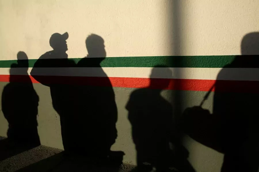 After being deported from the United States, Mexican immigrants cast shadows on a National Institute of Migration (INM) building in Ciudad Juarez, Mexico, on April 21, 2020.