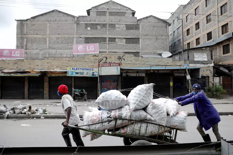 People move a cart, after the government announced a lockdown of Nairobi's storied Eastleigh district and the Old Town of Mombasa for two weeks following a jump in confirmed coronavirus disease (COVID-19) cases there, Nairobi, Kenya May 7, 2020
