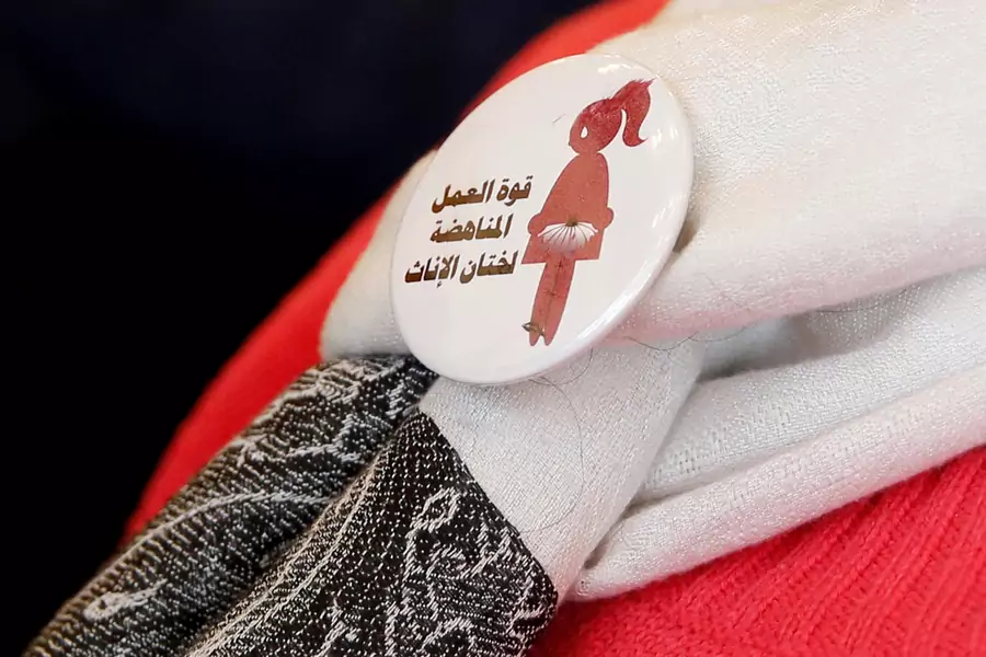 A volunteer at a conference on International Day of Zero Tolerance for Female Genital Mutilation (FGM) in Cairo, Egypt, wears a badge that reads "The power of labor against FGM." February 6, 2018.