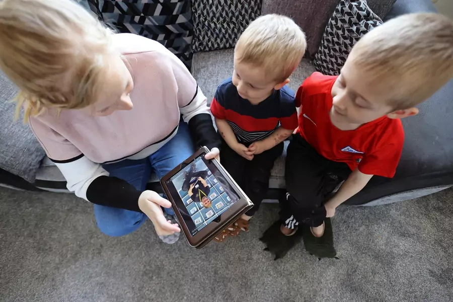 Children listen to stories posted by nursery staff on their app and Facebook to help parents who are stuck at home, as the spread of COVID-19 continues in Britain. 