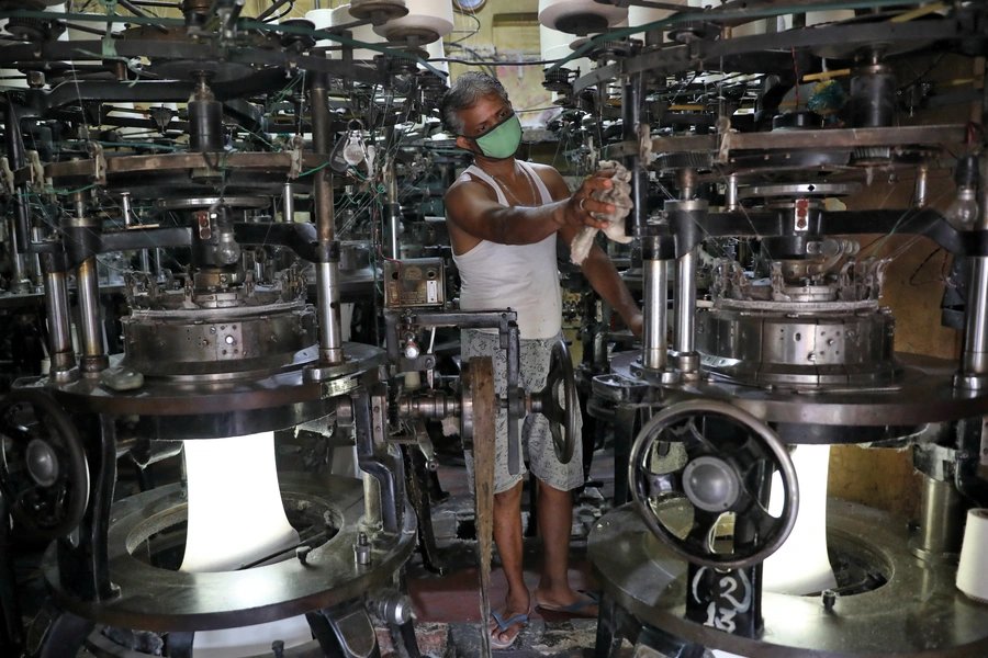 A worker in a recently reopened undergarment factory in Kolkata, India.