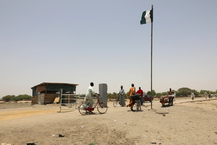 People walk across the Gamboru Ngala bridge linking Cameroon with Nigeria, Borno, Nigeria, on April 27, 2017. 