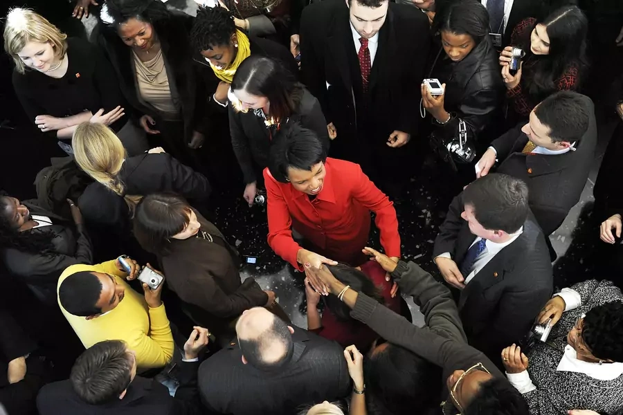 U.S. Secretary of State Condoleezza Rice is surrounded as she bids farewell to a lobby filled with employees after her last day at the State Department in Washington, January 16, 2009. 