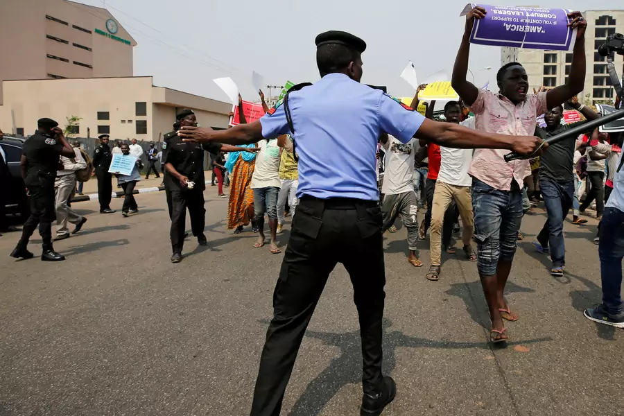 Nigerian police officers try to disperse protesters, some supporting and some opposing the suspension of the Chief Justice of Nigeria (CJN) Walter Onnoghen, in Abuja, Nigeria, on January 28, 2019.
