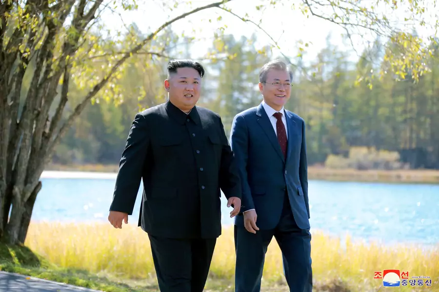 South Korean President Moon Jae-in and North Korean leader Kim Jong-un walk during a luncheon, in this photo released by North Korea's Korean Central News Agency (KCNA) on September 21, 2018. 