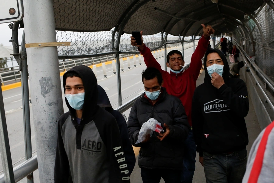 Mexican migrants deported from the U.S. are pictured at Paso del Norte International Border bridge after the U.S. and Mexico have agreed to restrict non-essential travel over their shared border to limit the spread of coronavirus disease (COVID-19).