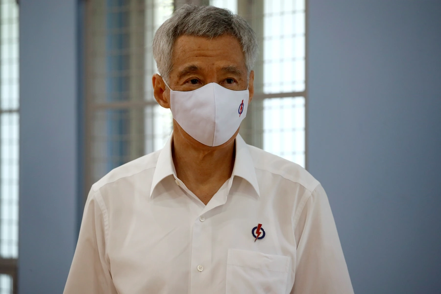 Singapore's Prime Minister Lee Hsien Loong of the ruling People's Action Party, wearing a face mask, prepares to give a speech at a nomination center ahead of the general election in Singapore on June 30, 2020.