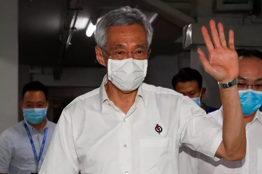 Singapore's Prime Minister Lee Hsien Loong waves as he arrives at a People's Action Party branch office, as ballots are being counted during the general election, in Singapore on July 11, 2020.