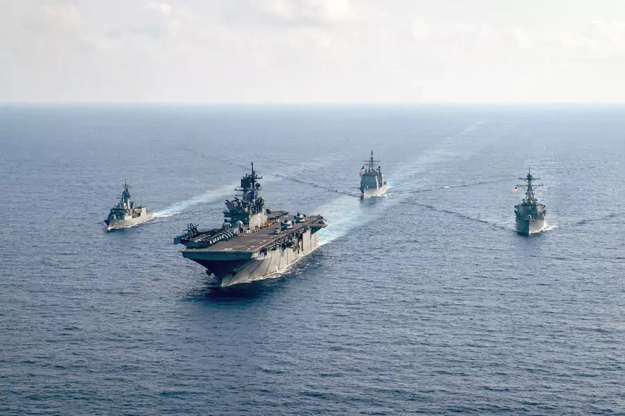 The Royal Australian Navy HMAS Parramatta (L) is underway with the U.S. Navy USS America, the USS Bunker Hill, and the USS Barry in the South China Sea on April 18, 2020. 