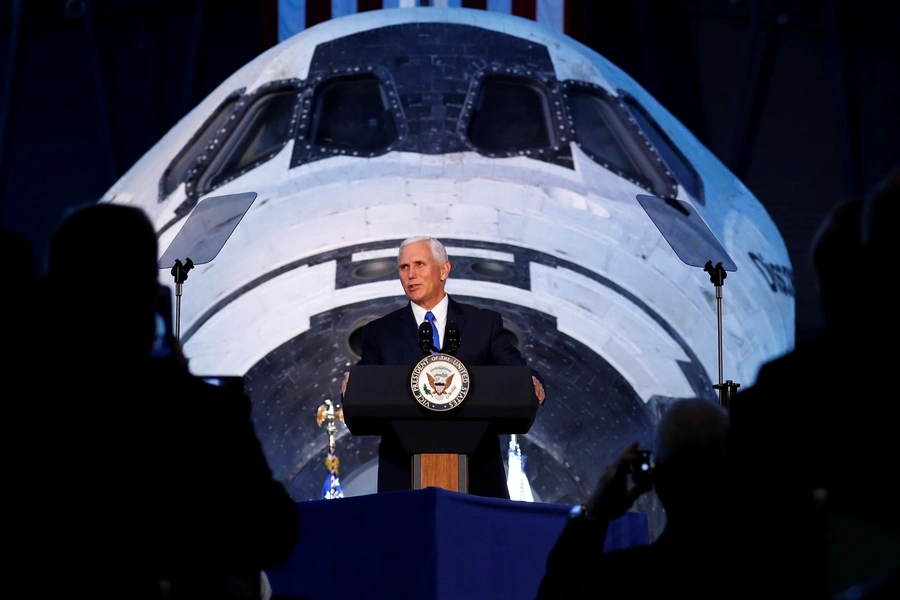 Vice President Mike Pence in front of the Space Shuttle Discovery.