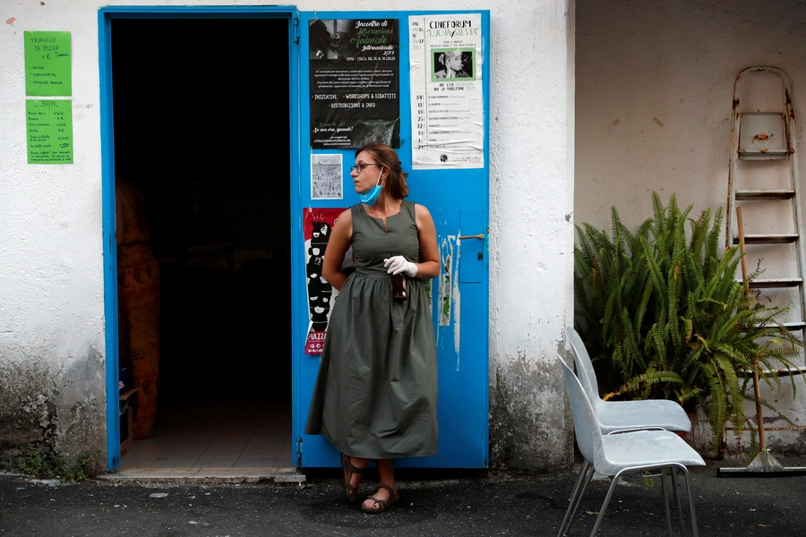 An activist from Lucha y Siesta (Fight and Rest) women's house, a building run by activists to care for domestic violence survivors, attends a film screening at the house. Rome, Italy. July 7, 2020.