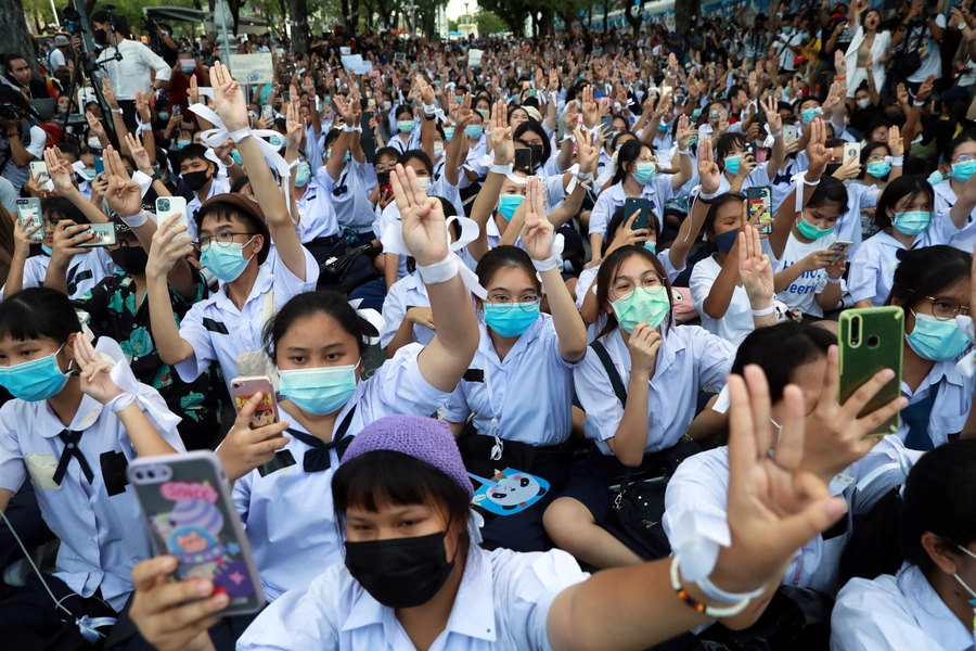 Anti-government protesters and students welcome Thailand's Education Minister Nataphol Teepsuwan with a three-fingers salute during a demonstration demanding the government to resign in Bangkok, Thailand on September 5, 2020.