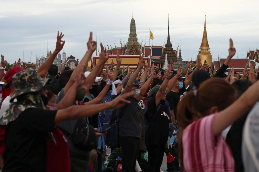 Pro-democracy protesters display the three-fingered salute while singing the national anthem during a mass rally to call for the ouster of Prime Minister Prayuth Chan-ocha's government and reforms in the monarchy, in Bangkok on September 20, 2020.