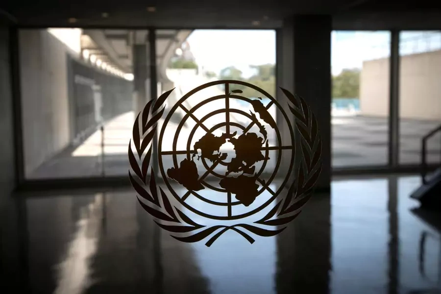 The United Nations logo is seen on a window in an empty hallway at UN headquarters during the seventy-fifth annual UN General Assembly on September 21, 2020. 