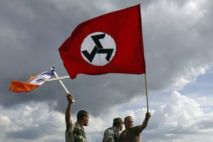 Supporters of the Afrikaner Resistance Movement (AWB) leader Eugene Terre'Blanche wave the party's flag (R) and an apartheid era flag during his funeral in Ventersdorp in South Africa's North West Province, on April 9, 2010.