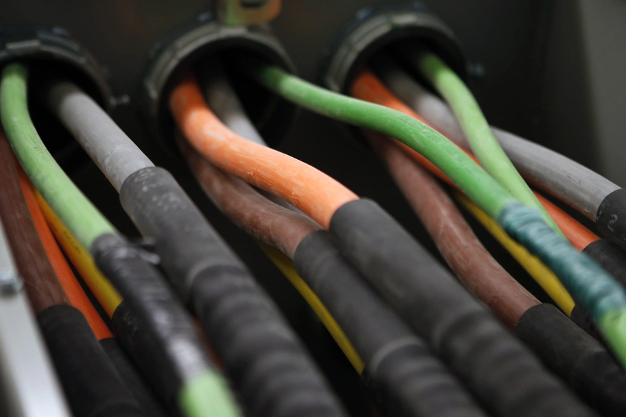 Fiber optic cables carrying internet providers are seen running into a server room.