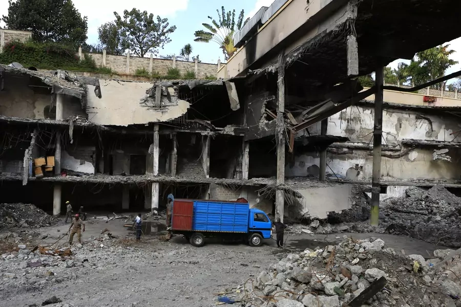 Men work on a damaged section of the Westgate Shopping Mall, after al-Shabab militants launched an attack on the mall in September 2013, in Nairobi on January 21, 2014.