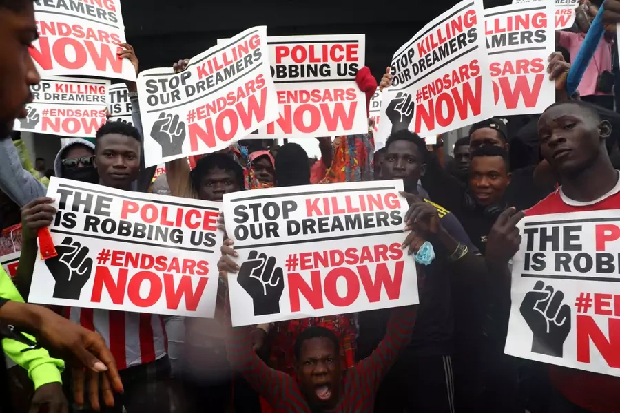 Demonstrators carry banners during a protest over alleged police brutality, in Lagos, Nigeria on October 14, 2020.