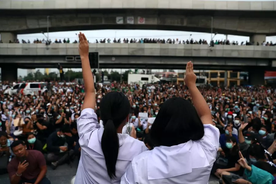Pro-democracy protesters show the three-finger salute during an anti-government protest, in Bangkok, Thailand on October 19, 2020.