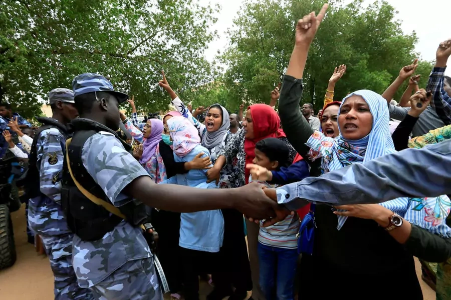 Sudanese chant slogans outside a court during a new trial against ousted President Omar al-Bashir and some of his former allies over the military coup that brought the autocrat to power in 1989, outside a courthouse in Khartoum, Sudan. September 15, 2020