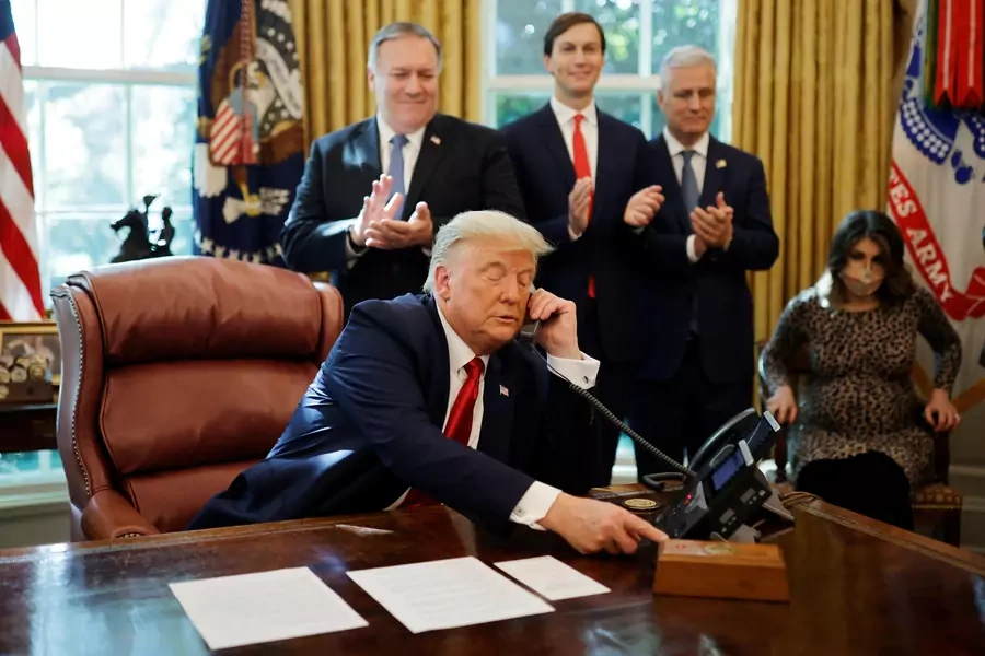 U.S. President Donald Trump speaks on the phone with leaders of Israel and Sudan about the decision to rescind Sudan's designation as a state sponsor of terrorism, in the Oval Office at the White House in Washington, U.S., October 23, 2020