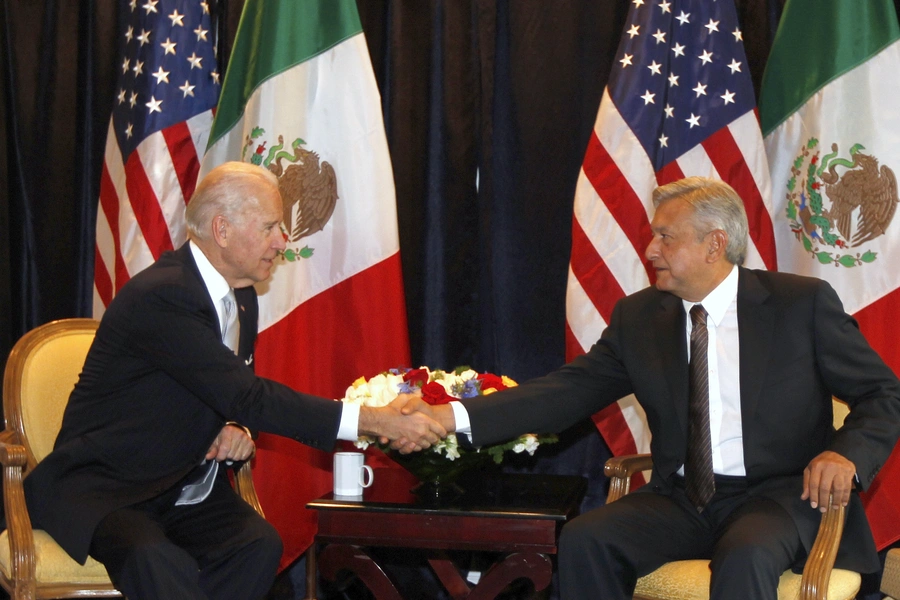 U.S. Vice President Joseph Biden (L) shakes hands with Andres Manuel Lopez Obrador, presidential candidate for the Party of the Democratic Revolution (PRD) during a photo opportunity in Mexico City March 5, 2012. 