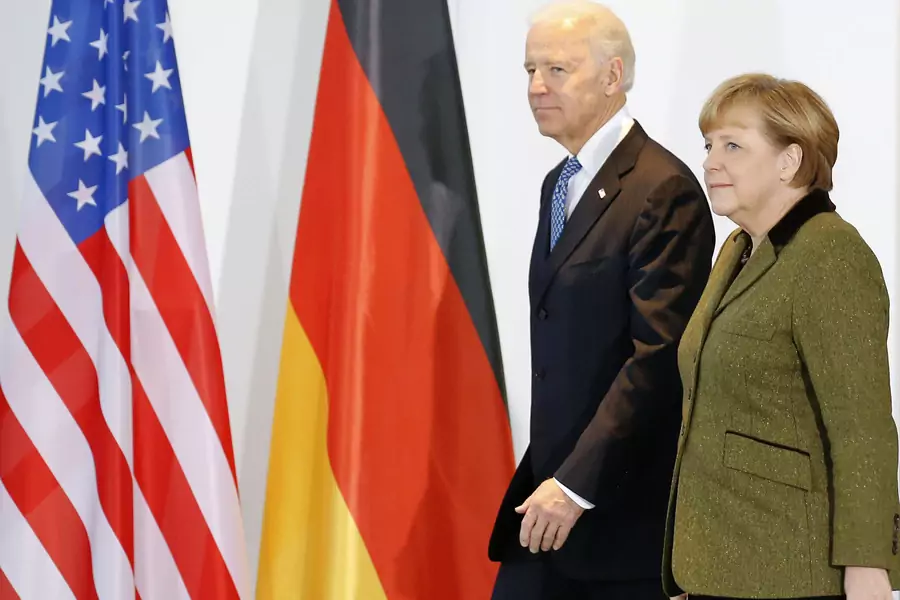 Then-U.S. Vice President Joe Biden and German Chancellor Angela Merkel walk together in Berlin on February 1, 2013. 