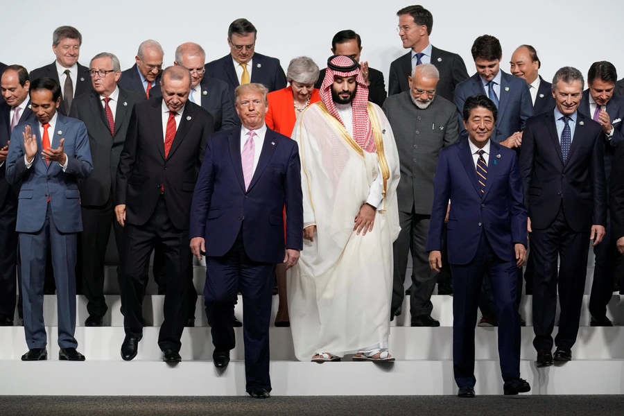 Japan's Prime Minister Shinzo Abe and U.S. President Donald Trump walk off with fellow leaders after a family photo session at the G20 leaders summit.