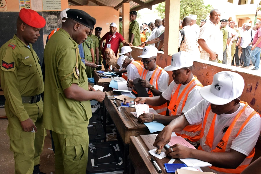 Tanzanian government officials are processed before casting their ballots at a polling centre during the early voting for essential workers at the presidential and parliamentary polls in the semi-autonomous island of Zanzibar, Tanzania October 27, 2020