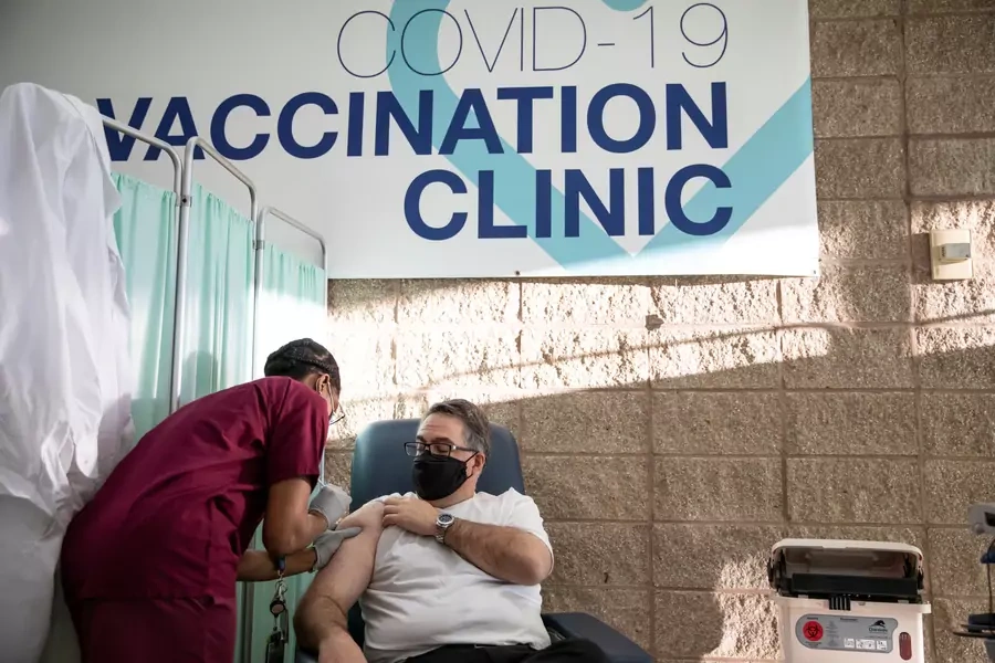A man receives the Pfizer-BioNTech coronavirus vaccine at University Hospital in Newark, New Jersey on December 15, 2020.