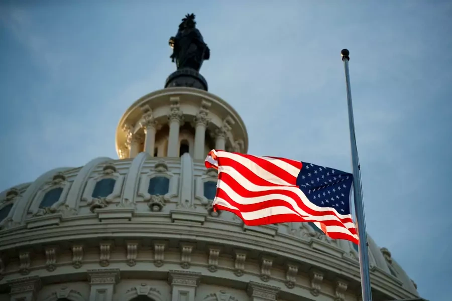 The American flag flying at half staff at the United States Capitol on December 3, 2018. Shawn Thew/Pool via Reuters