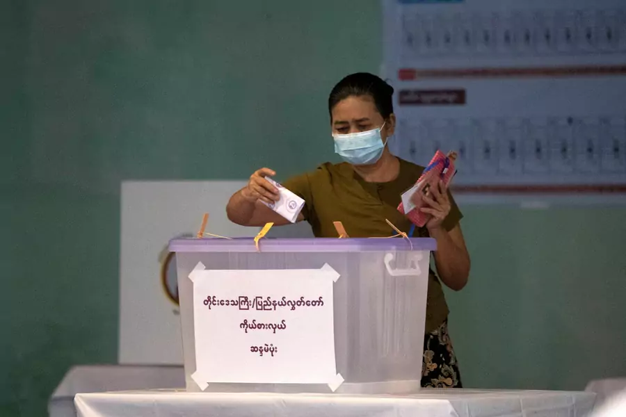 A voter casts her ballot during Myanmar's general election on November 8, 2020.