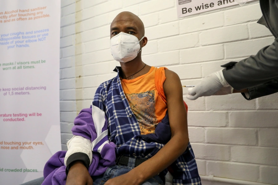 A volunteer receives an injection from a medical worker during the country's first human clinical trial for a potential vaccine against the novel coronavirus, at the Baragwanath hospital in Soweto, South Africa on June 24, 2020.