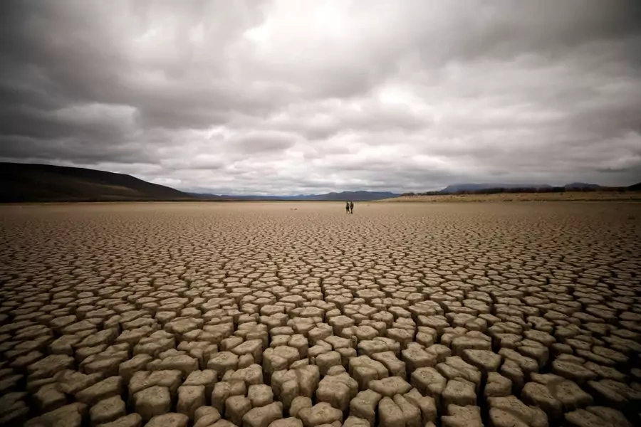 Clouds gather but produce no rain as cracks are seen in the dried up municipal dam in drought-stricken Graaff-Reinet, South Africa on November 14, 2019. 
