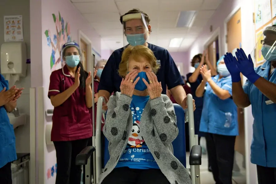 Margaret Keenan is applauded after she becomes the first person to receive a COVID-19 vaccine outside of clinical trials in Coventry, England, on December 8, 2020. 