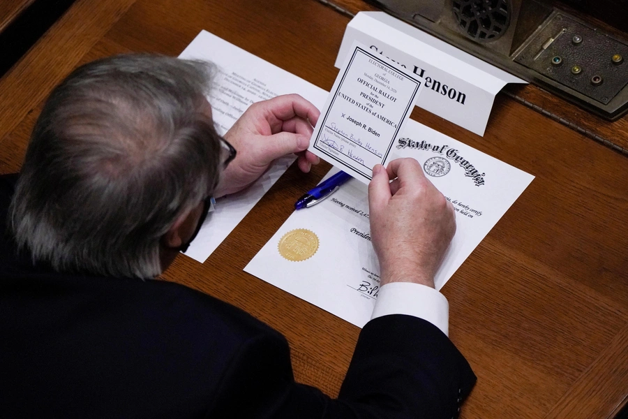 A Democratic delegate to the Electoral College casts a ballot for President-Elect Joe Biden in Atlanta, Georgia, on December 14, 2020. 