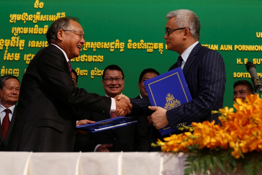 Chairman of the KrisEnergy Group Tan Ek Kia (L) shakes hands with Cambodian Minister of Economy and Finance Aun Pornmoniroth during a signing ceremony in Phnom Penh, Cambodia on August 23, 2017.