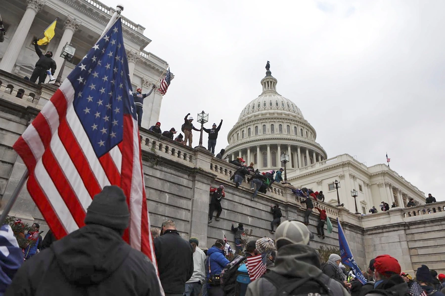 Supporters of U.S. President Donald Trump scale the walls of the U.S. Capitol Building in Washington, D.C. on January 6, 2021.