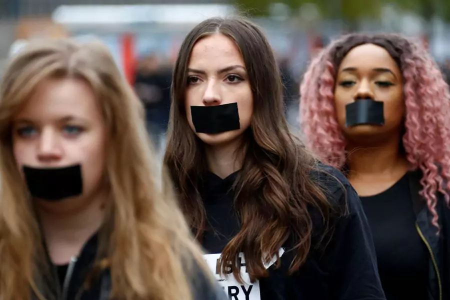 Women attend a protest against human trafficking in Berlin. 