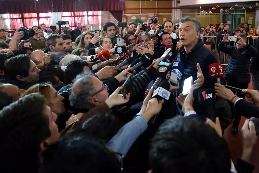 Then-President Mauricio Macri of Argentina speaks to journalists after casting his vote in Buenos Aires.