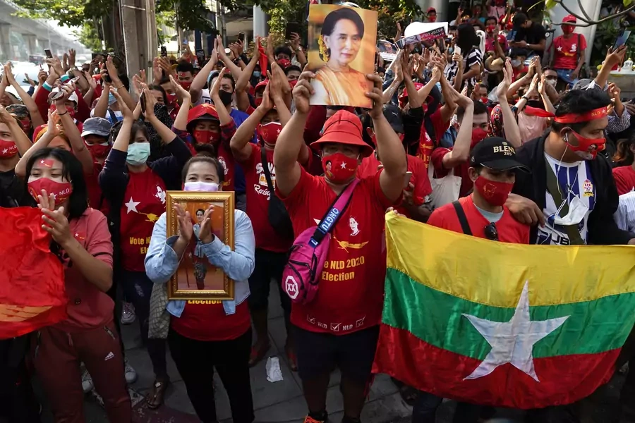 NLD supporters clap outside Myanmar's embassy in Bangkok, Thailand.