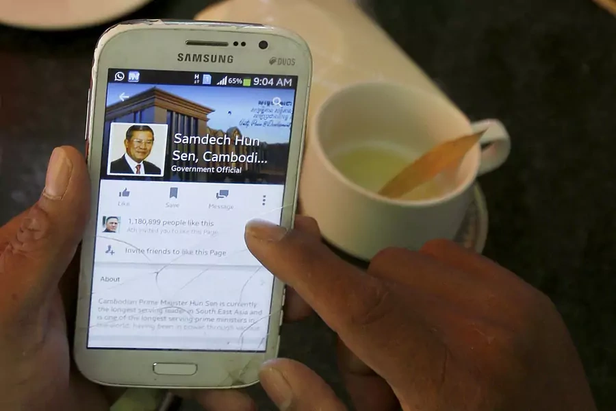 A person uses a smartphone to look at the Facebook page of Cambodia's Prime Minister Hun Sen.