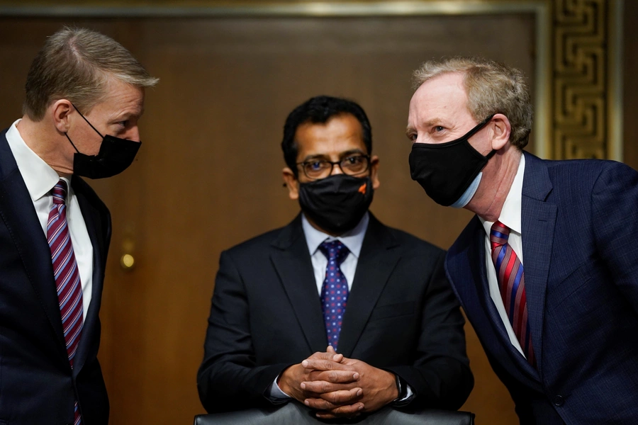 FireEye CEO Kevin Mandia, SolarWinds CEO Sudhakar Ramakrishna and Microsoft President Brad Smith speak with each other before the start of a Senate Intelligence Committee hearing.