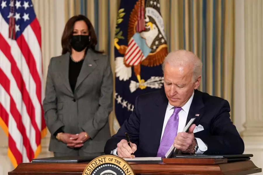 Vice President Kamala Harris looks on as President Joe Biden signs executive orders addressing racial equality. 