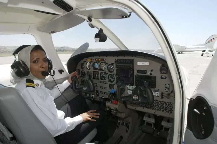 Hanadi Hindi, first female pilot from Saudi Arabia, sits in the cockpit of a plane prior to takeoff in Amman, Jordan in 2003. 